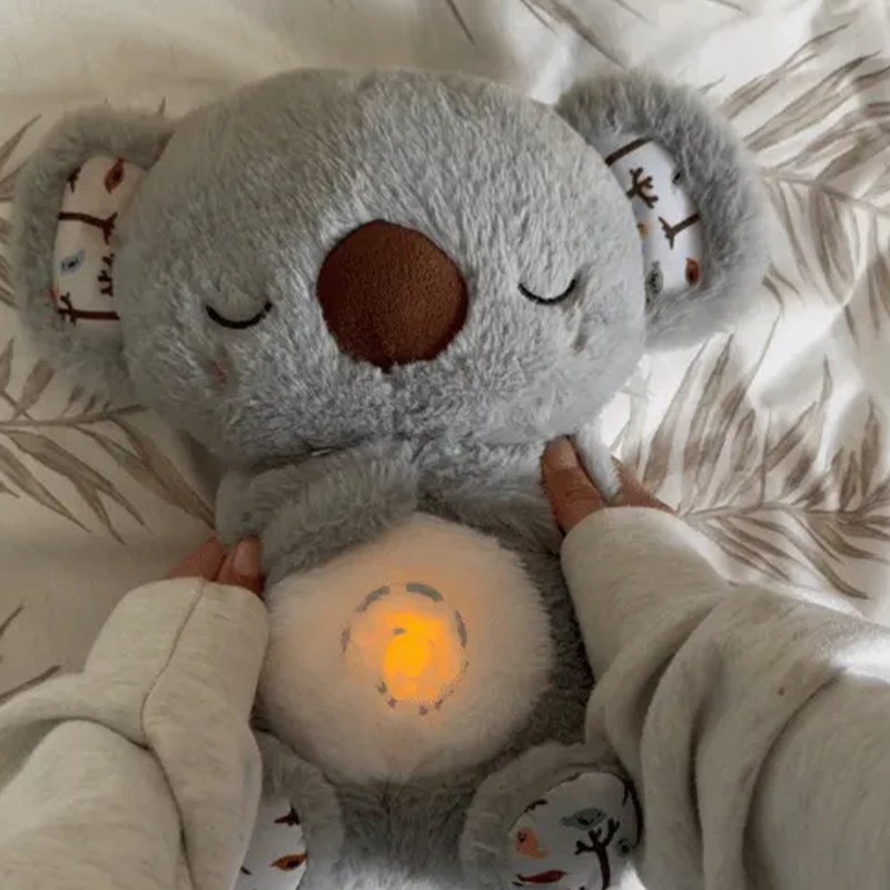 Close-up of the Froplay Koala Calm Buddy with its warm belly nightlight glowing