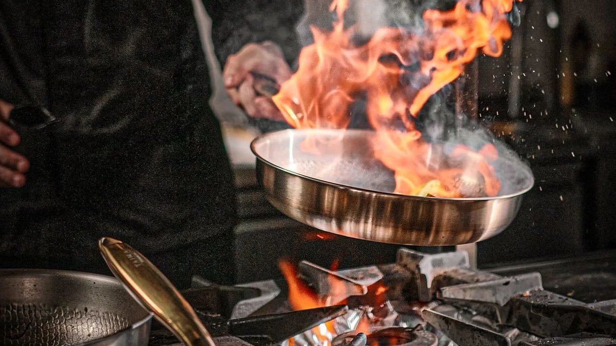 Titanium pan searing over an open flame